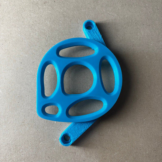 Blue plastic object with multiple holes on a gray background